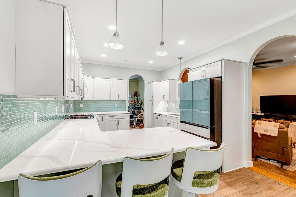 Kitchen Remodel with light blue cabinets, wood floors, stainless steel appliances, and marble countertops. Kitchen Remodel with light blue cabinets, wood floors, stainless steel appliances, and marble countertops.